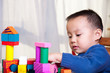 © ping han - kid play with wooden blocks