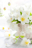 Fototapeta  - white tulips in a basket and easter colored eggs