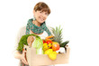 An attractive smiling woman holding a grocery bad on white