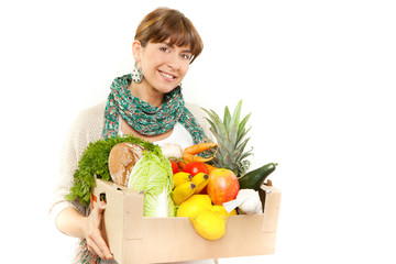 Poster - An attractive smiling woman holding a grocery bad on white