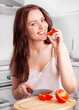 © LanaK - woman cutting tomatoes