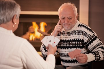 Poster - Elderly couple playing cards at home