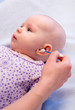 cleaning ears of baby with cotton swabs