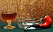 Pipe And A Glass Of Alcohol On Green Felt