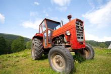 Old Abandoned Red Tractor With Removed Trademarks