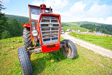 Old Abandoned Red Tractor With Removed Trademarks