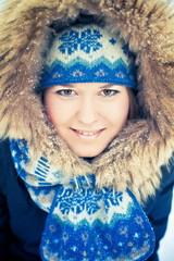 Happy young woman plays with a snow