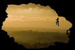 © veneratio - Two rock climbers silhouette against stunning sunset landscape c
