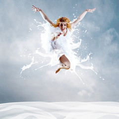 Jump of ballerina with dress of milk