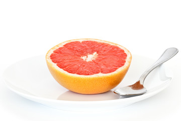 Wall Mural - half grapefruit on plate with spoon