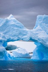 Wall Mural - large arctic iceberg with a cavity inside