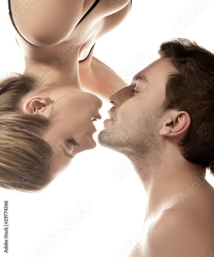 Fototapeta na wymiar Conceptual portrait of a young couple gentle kissing