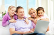© pressmaster - Family and laptop