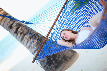 Wall Mural - Woman relaxing in hammock