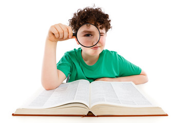 Boy looking through magnifying glass isolated on white