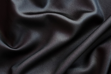Photo d'un arrière plan de tissu satiné de soie noir
