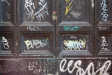 Dirty, Old, Black, Wooden Doors, Many White Graffiti On Doors