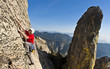 © Greg Epperson - Rock climber clinging to a cliff.