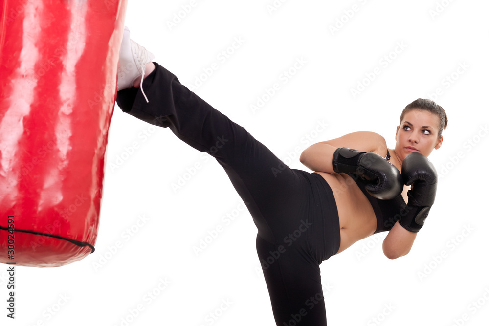 Fotografering woman kick a punching bag