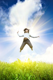 Fototapeta Sport - Young woman jumping into the field against the blue sky