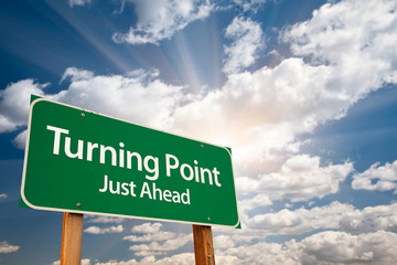 Wall Mural - Turning Point Green Road Sign and Clouds