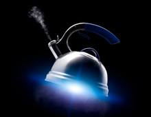 Tea Kettle With Boiling Water On Black Background.
