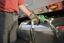 Man Fueling Up A Freight Transport Truck