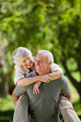 Man giving wife a piggyback