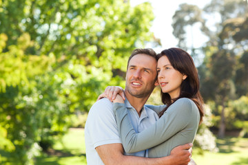 Canvas Print - Radiant couple hugging in the park