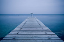 Lonely Chair On A Wooden Pier