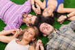 © william87 - Young People Lying on Green Ground with Hands Joined