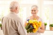 © nyul - Happy elderly woman getting flowers
