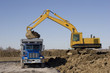 Excavator and dumptruck on construction site