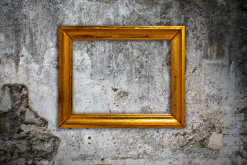 Gold frame on a old wall background