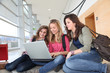 © goodluz - Group of teenage girls at school with laptop computer