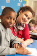 © Monkey Business - Schoolboy Studying In Classroom With Teacher