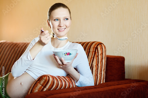 Smiling Beautiful Pregnant Woman Eating Cottage Cheese Buy This