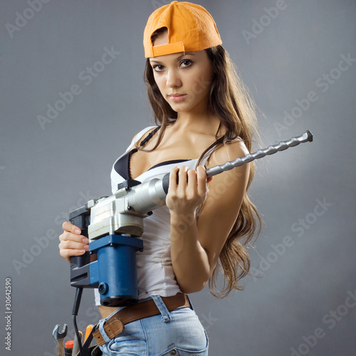 Naklejka ścienna sexy young woman construction worker