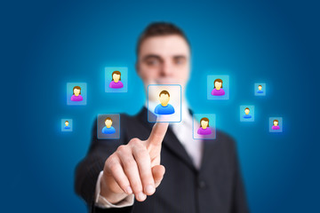 Businessman hand pressing Social network icon 2