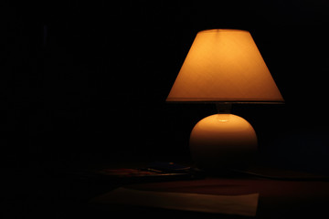 ancient lamp on table in the dark