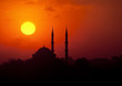 The sun sets behind a silhouetted mosque in Istanbul, Turkey