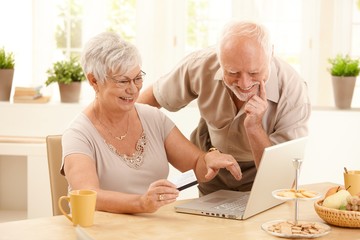 Poster - Happy older couple doing online shopping