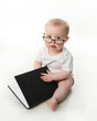 © blessings - Baby reading wearing glasses