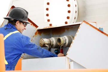 Man Working On Oilfield Machinery