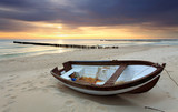 Fototapeta Zachód słońca - Boat on beautiful beach in sunrise