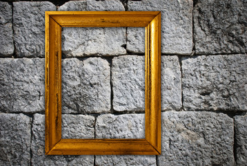 Gold frame on a old wall background