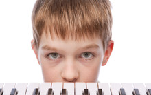 Sad Boy Near Piano Keyboard