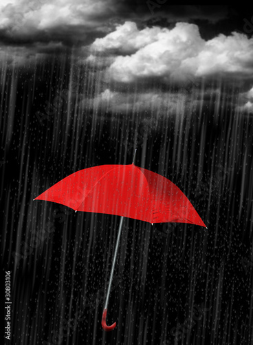 Fototapeta na wymiar red umbrella in heave rain