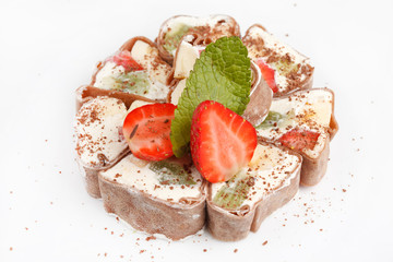 Wall Mural - Tiramisu Sushi Roll garnished with Strawberry and Mint