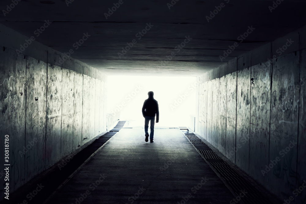 Silhouette of Man Walking in Tunnel. Light at End of Tunnel - obrazy, fototapety, plakaty 
